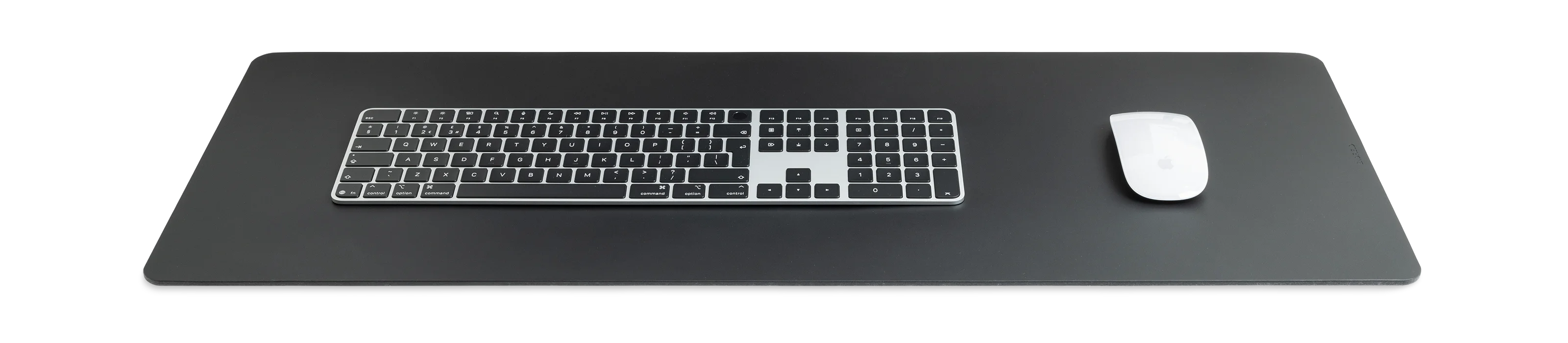 Large black leather desk pad with keyboard and mouse on a white background
