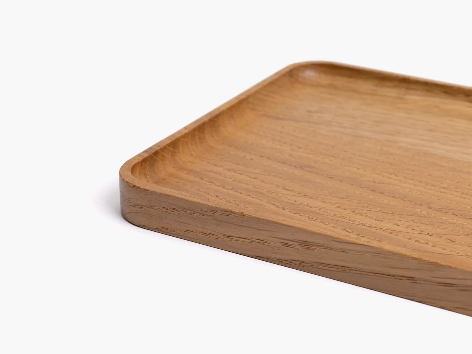 Wooden oak catchall tray on a white background.